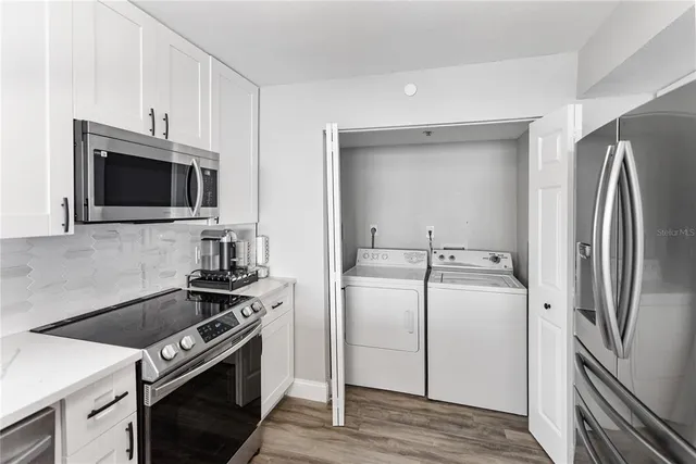 a kitchen with a refrigerator stove and microwave