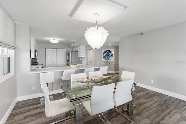 a view of a dining room with furniture wooden floor and chandelier