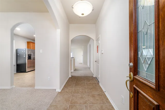 a view of a hallway with wooden floor and glass door