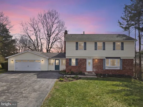 a front view of a house with a garden and yard