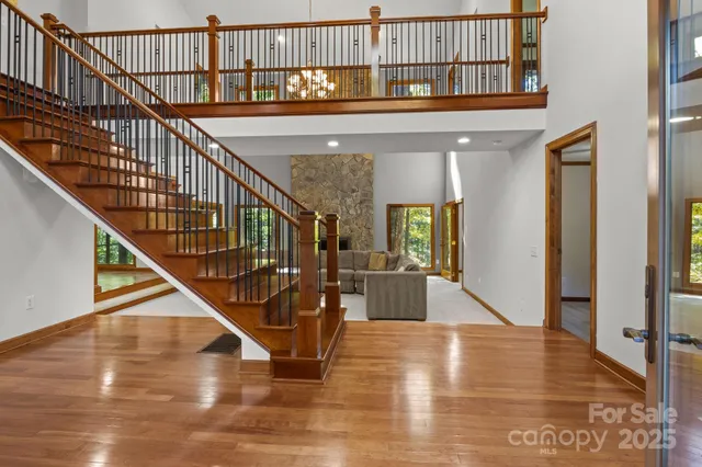 a view of entryway and hall with wooden floor