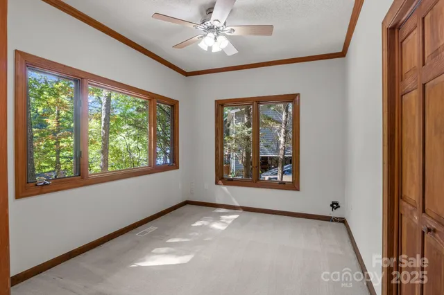 a view of a livingroom with a ceiling fan and window