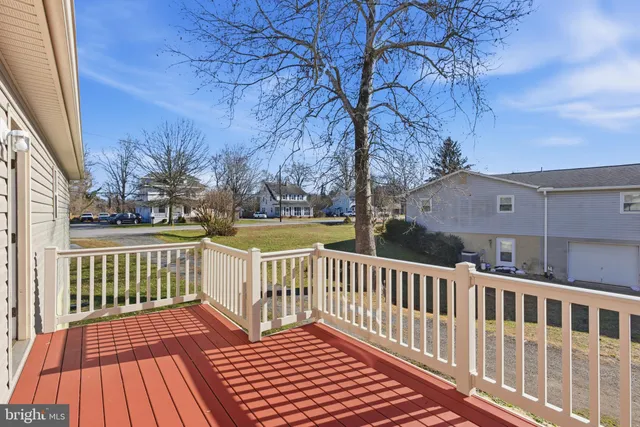 a view of a wooden deck with a yard