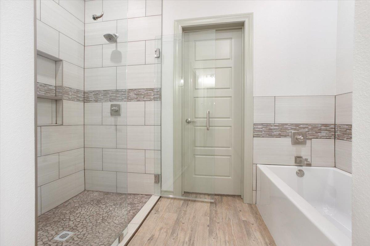 5846 Harvard Street Lubbock, TX 79416 - Photo 13 of 24 a bathroom with a bathtub and shower