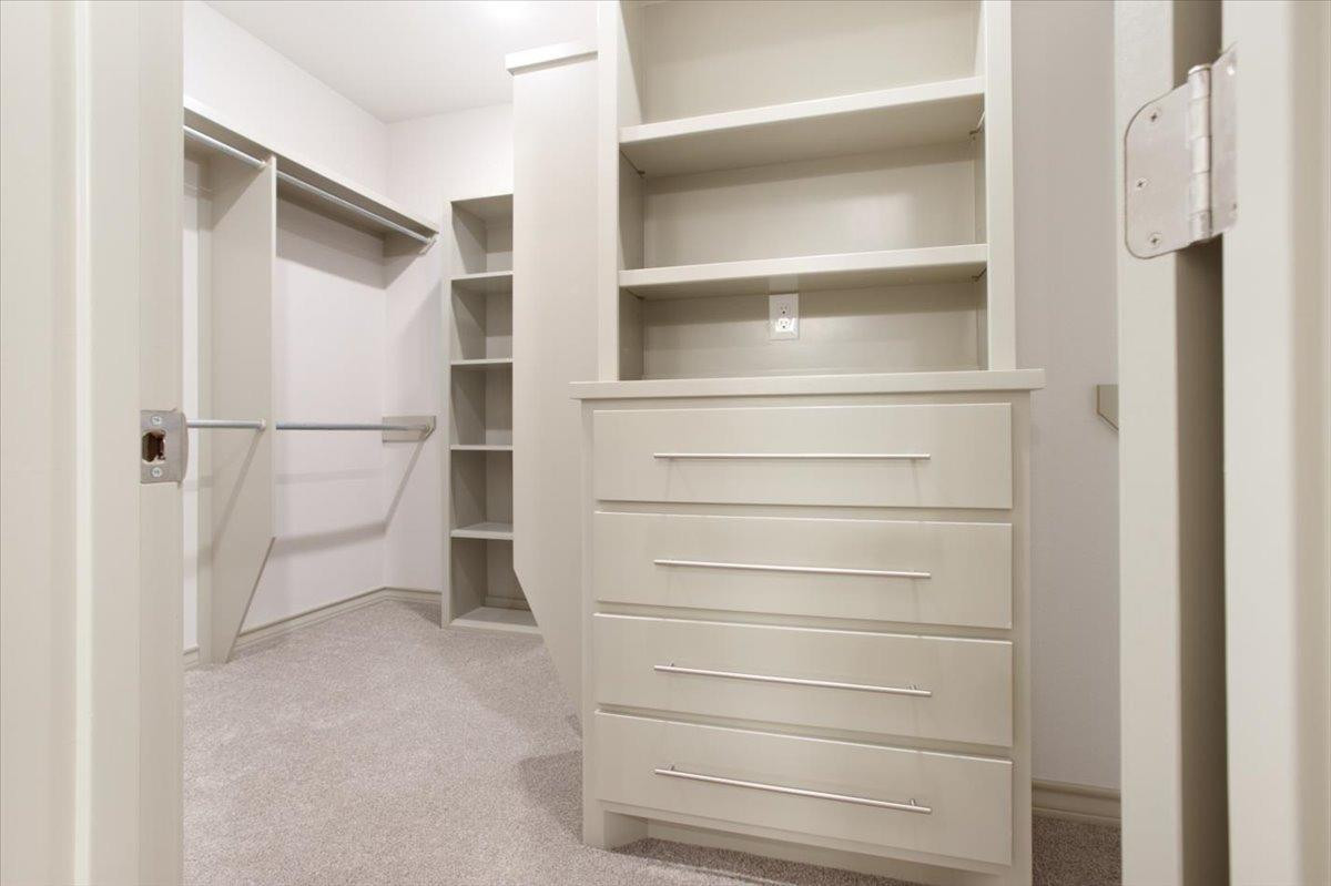 5846 Harvard Street Lubbock, TX 79416 - Photo 14 of 24 a view of walk in closet with empty racks