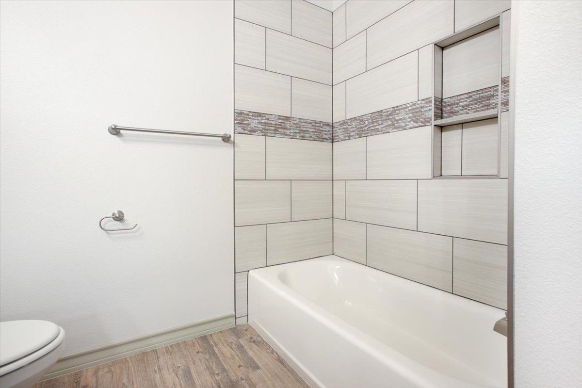 5846 Harvard Street Lubbock, TX 79416 - Photo 18 of 24 a bathroom with a bathtub and shower