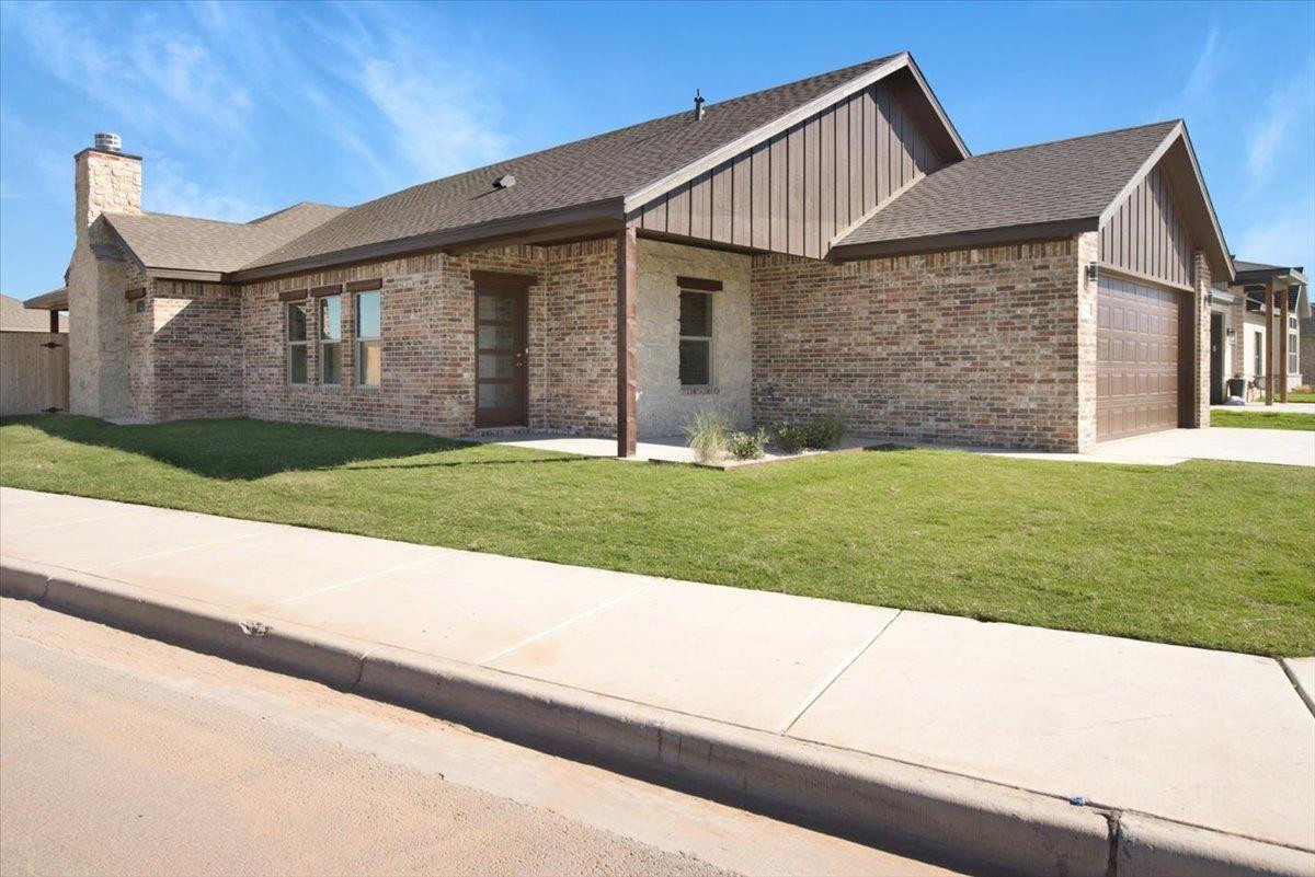 5846 Harvard Street Lubbock, TX 79416 - Photo 24 of 24 a front view of a house with a yard and garage
