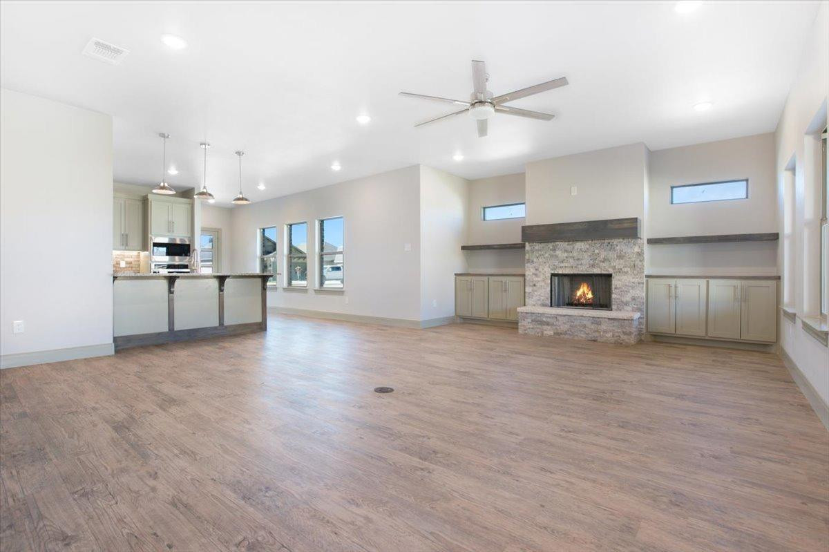 5846 Harvard Street Lubbock, TX 79416 - Photo 3 of 24 an empty room with kitchen and fireplace