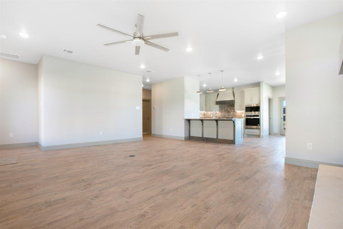 5846 Harvard Street Lubbock, TX 79416 - Photo 4 of 24 a view of a kitchen with a stove top oven a sink and dishwasher