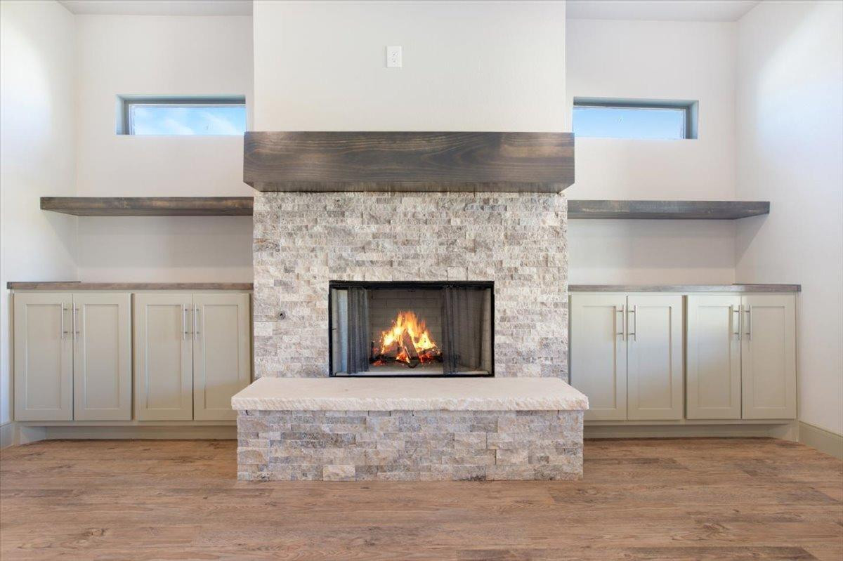 5846 Harvard Street Lubbock, TX 79416 - Photo 6 of 24 a living room with furniture and a fireplace