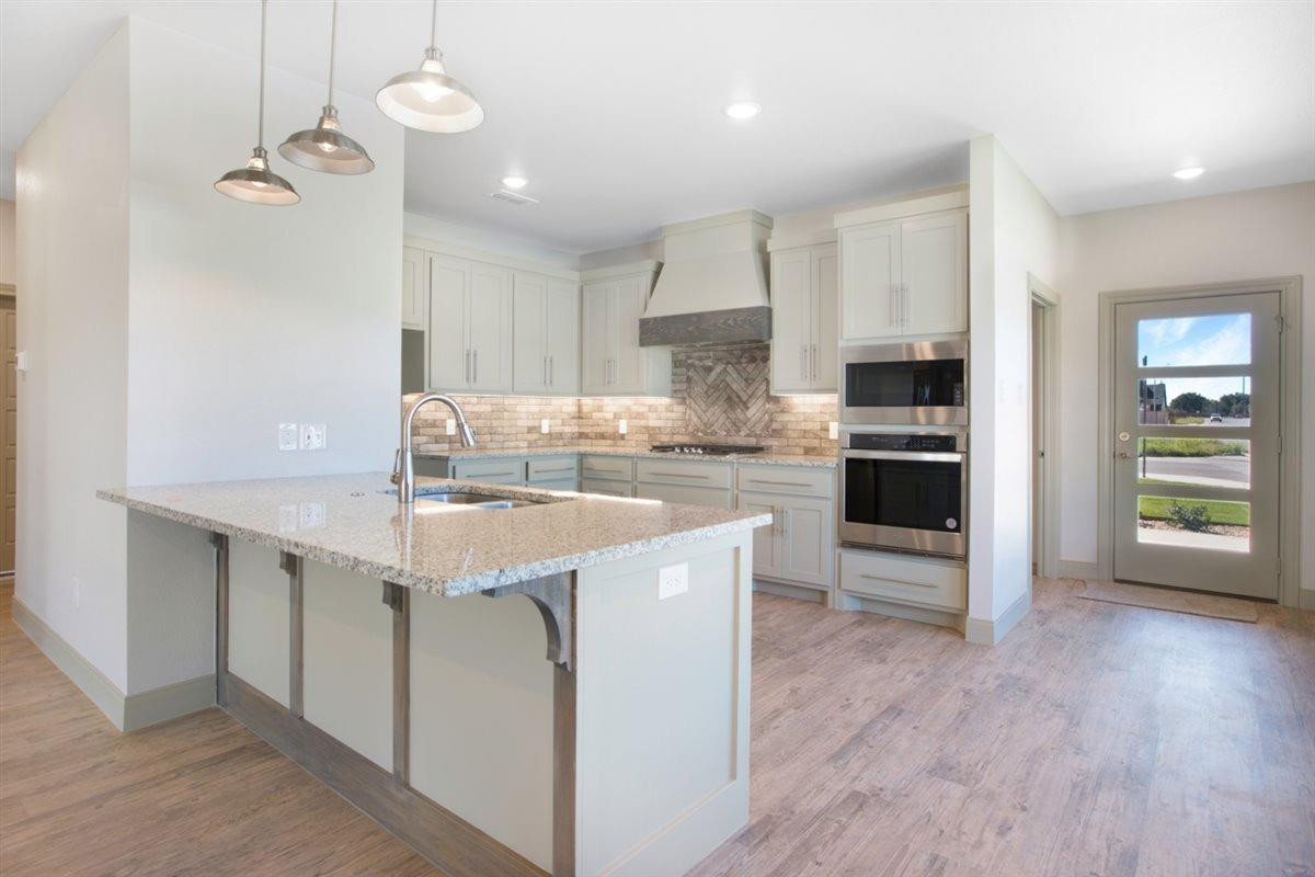 5846 Harvard Street Lubbock, TX 79416 - Photo 7 of 24 a kitchen with a sink a stove a refrigerator and a cabinets