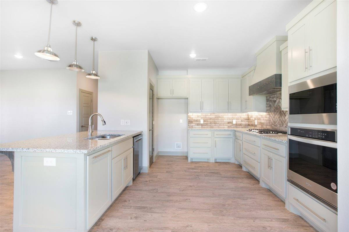 5846 Harvard Street Lubbock, TX 79416 - Photo 8 of 24 a kitchen with a sink stove and microwave