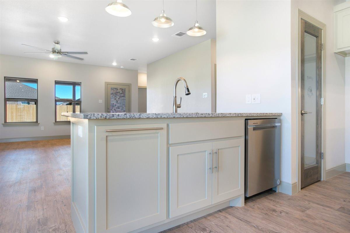 5846 Harvard Street Lubbock, TX 79416 - Photo 9 of 24 a spacious bathroom with a granite countertop sink a mirror and shower