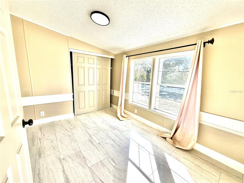 17726 Dorman Road Lithia, FL 33547 - Photo 12 of 16 a large bed sitting in a bedroom next to a window