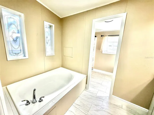 a bathroom with a tub and shower