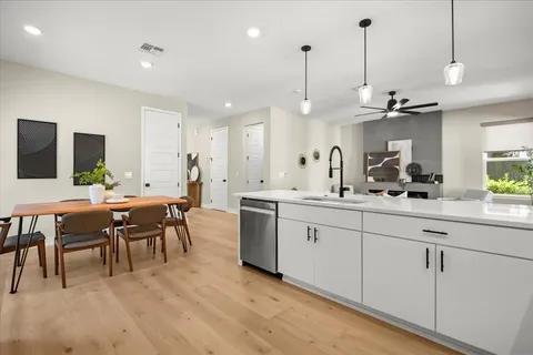 a large kitchen with kitchen island a sink table and chairs