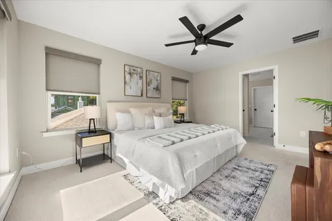 a bedroom with a bed and a large window