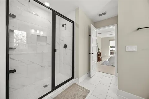 a bathroom with a glass shower door