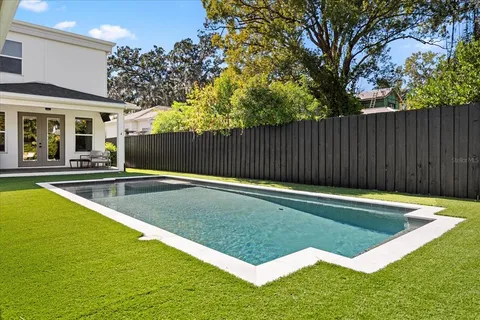 a view of swimming pool with chairs in patio