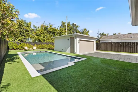 a view of a backyard with a house and large trees