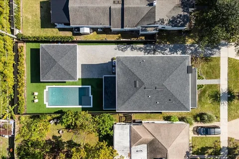 an aerial view of a house with a yard and a fountain