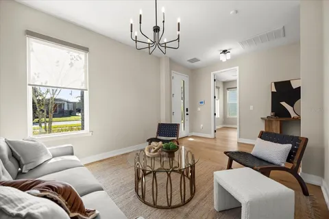 a living room with furniture a window and a chandelier