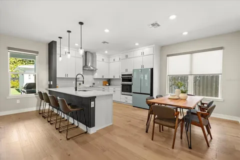a view of a dining room with furniture window and wooden floor