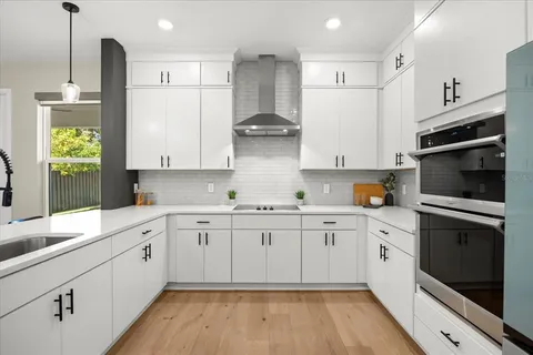 a kitchen with stainless steel appliances granite countertop a stove a sink and a refrigerator