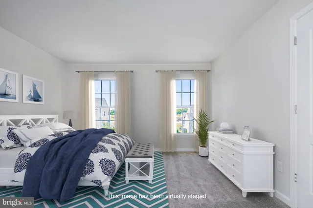 a spacious bedroom with a bed and a window