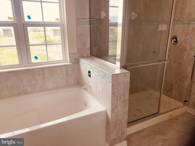 a bathroom with a bathtub and shower