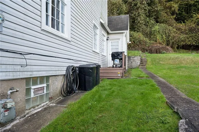 a view of a white house with large windows and yard