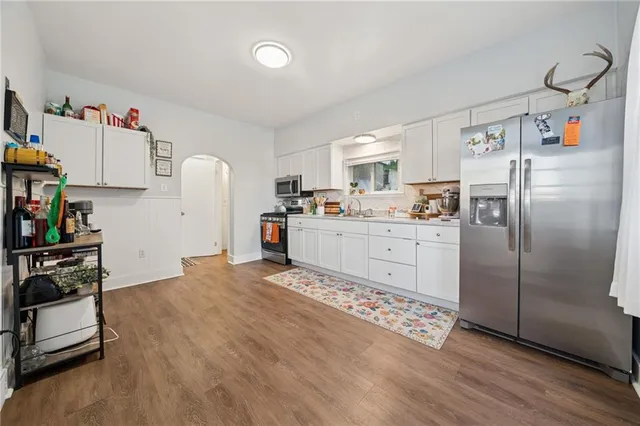 a kitchen with stainless steel appliances a refrigerator sink and cabinets