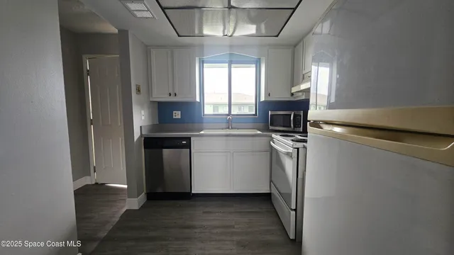 a kitchen with a stove and a refrigerator