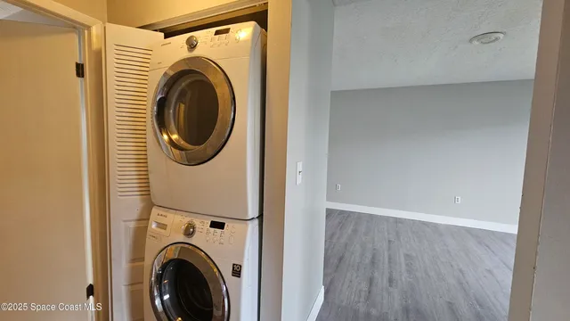 a view of a hallway with washer and dryer