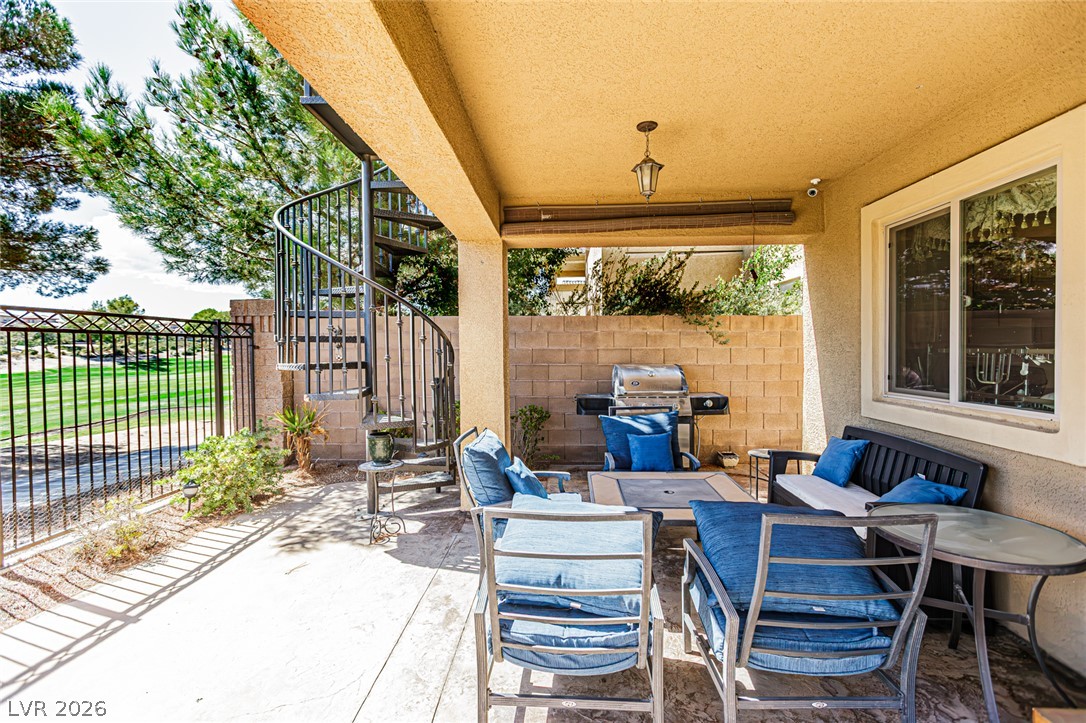 75 Tall Ruff Drive Las Vegas, NV 89148 - Photo 55 of 64 A covered concrete patio provides shelter alongside a spiral staircase and scenic golf course views.