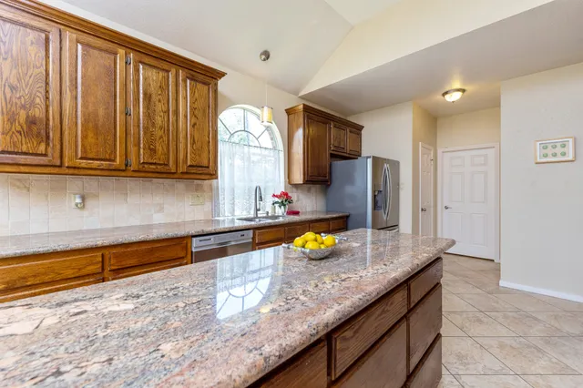 a kitchen with sink cabinets and window