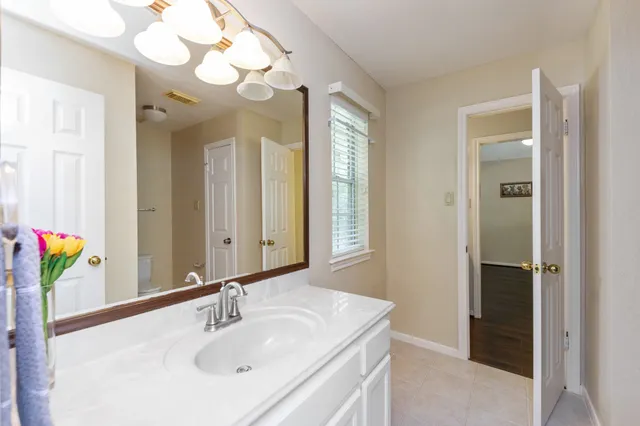 a bathroom with a sink a mirror and a shower