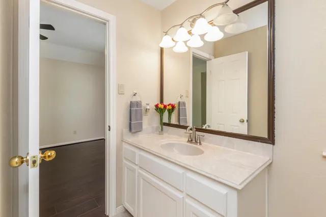 a bathroom with a sink vanity and a mirror