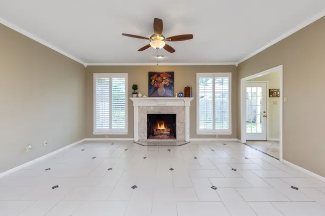 a view of an empty room with window and fireplace