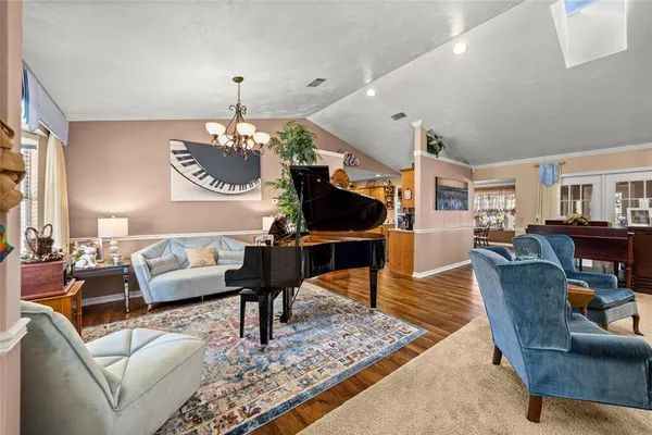 a living room with furniture a rug and a chandelier