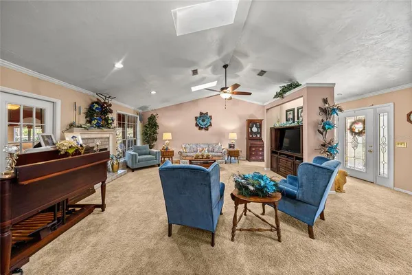 a living room with furniture kitchen view and a fireplace