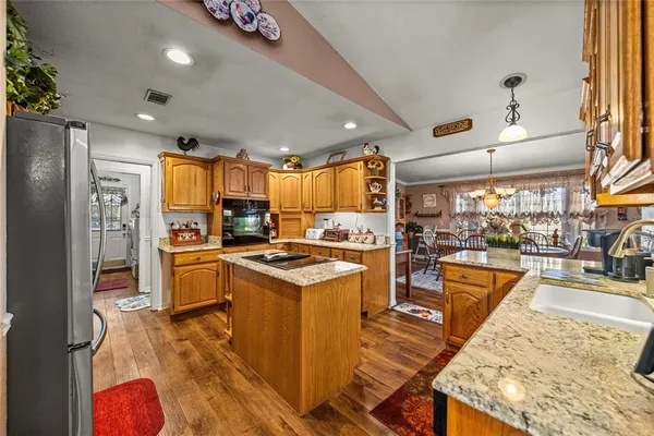 a living room with fireplace furniture and a rug