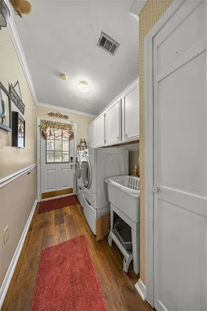 a bedroom with a bed and a flat tv screen on dresser