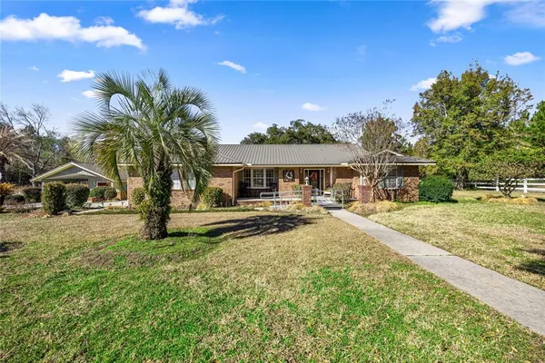 a front view of a house with outdoor seating