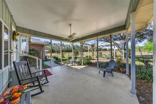 a view of a patio with table and chairs potted plants