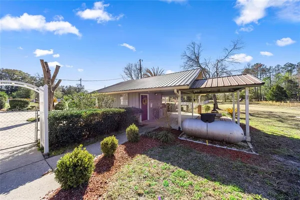 a building outdoor space with patio furniture and potted plants