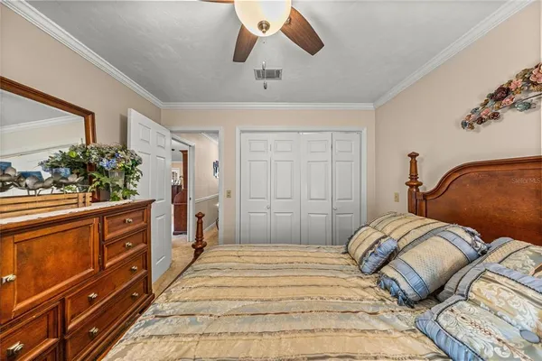 a bedroom with a large bed and a chandelier