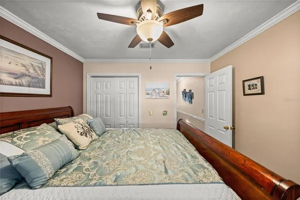 a bedroom with a bed and a chandelier