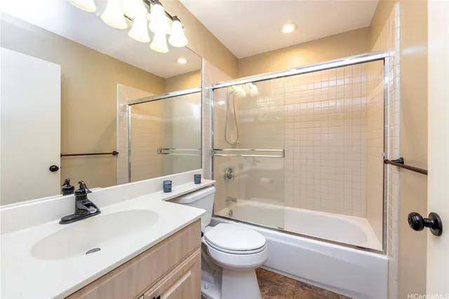 a bathroom with a sink vanity mirror and toilet