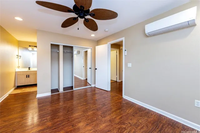 a view of a big room with wooden floor and a ceiling fan